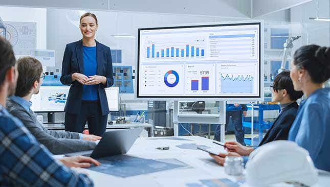 Business Solution Group cybersecurity team analyzing performance data on charts