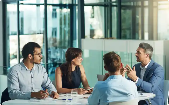 people sitting around a meeting table